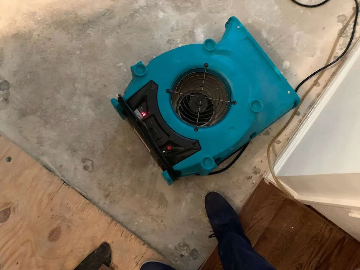 Air mover drying subfloor during Commercial Water Damage Restoration in Lemoore Station